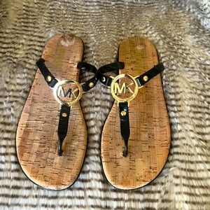 Michael Kors cork sandal black patent leather with gold MK emblem.